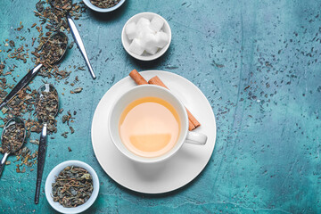 Composition with dry leaves and cup of green tea on grunge background