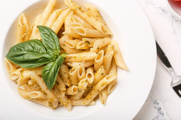 Plate with tasty pasta and pesto sauce, closeup