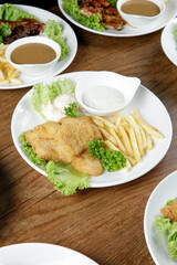 a plate of fish and chip set come with french fries and coleslaw