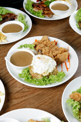 a plate of Chicken Chop set come with french fries and coleslaw