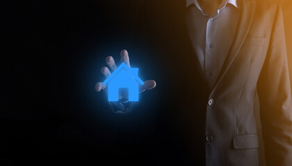 Real estate concept, businessman holding a house icon.House on Hand.Property insurance and security...