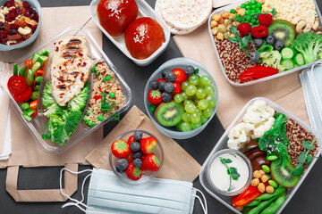 Takeaway lunch boxes with homemade nutrition food - meat, vegetables and fruits.