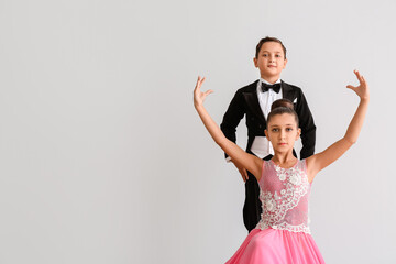 Cute little children dancing against light background