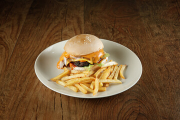 super delicious burger with melted cheese and french fries