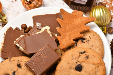 sweet food top view background for merry christmas or new year holiday decoration - chocolate candies, tangerines, cookies on white wood
