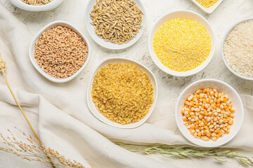 Bowls with assortment of cereals on white background