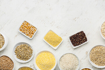 Bowls with assortment of cereals on white background