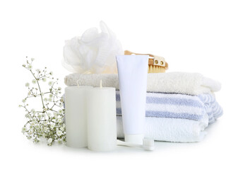 Aroma candles with bathing supplies on white background