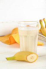 Glass of tasty banana smoothie on table