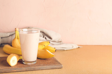 Glass of tasty banana smoothie on table