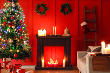 Burning candles in living room decorated for Christmas