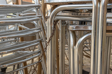 Metal chairs and tables stacked