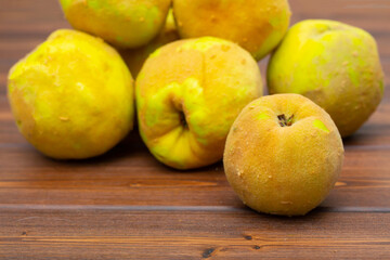 Quince fruit close-up on a wooden background.