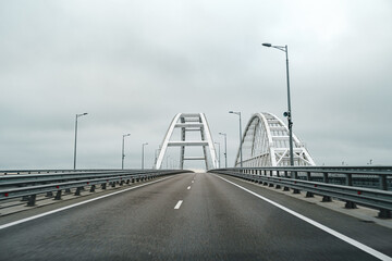 Empty highway with asphalt road and cloudy sky