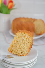 Fresh vanilla bundt cake on a wooden cutting board