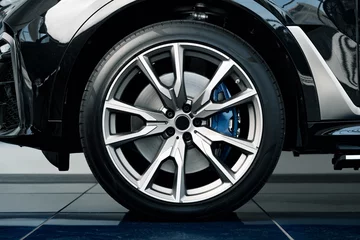 Fotobehang Aluminium rim of luxury car wheel close up © fotofabrika