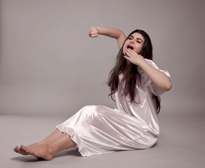 Woman in night gown stretching