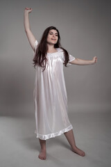 Naklejka premium Woman in night gown stretching