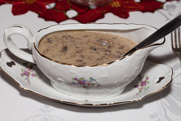 Christmas mushroom sauce in white porcelain tableware