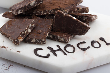 Broken or cracked chocolate chips pieces isolated on white background.