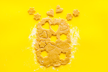 Fototapeta na wymiar Cutting out heart-shaped cookies on dough top view
