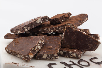 Broken or cracked chocolate chips pieces isolated on white background.