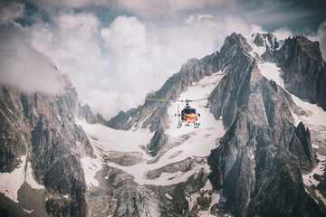 Helicopter flying over mountains in the alps