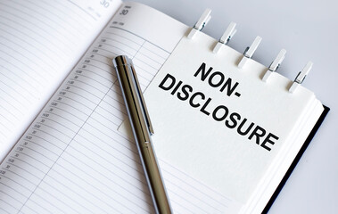 text Non-Disclosure on the short note texture background with pen. Business concept