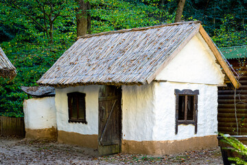 Traditional white slavic house with a thatched roof