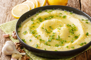 Vegetarian appetizer Skordalia of potatoes with garlic, lemon, nuts and olive oil close-up in a...