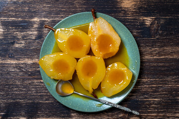 Baked pears in orange juice, close up. Delicious dessert.