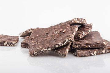 Broken chocolate chips pieces isolated on white background