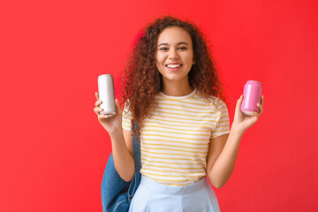 Beautiful African-American woman with soda on color background