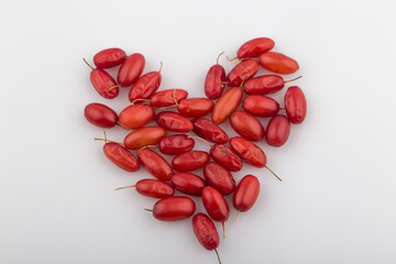 Pile of fresh cornus fruit on a white background.