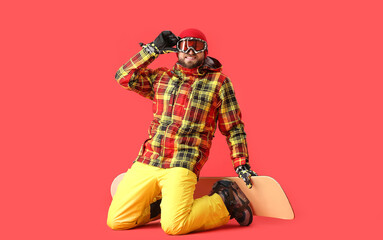 Male snowboarder on color background