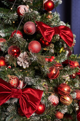 red velvet bows and red balls on a snow-covered tree