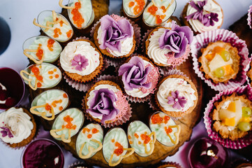 Sweet table. A plates of cakes and muffins. Table with sweets, buffet. Dessert table for a party goodies for the wedding. Candy bar. Decorated delicious.