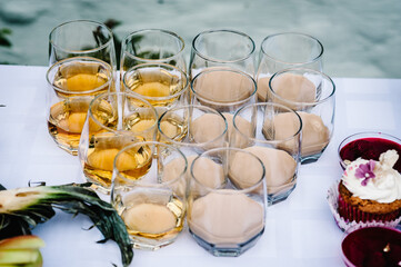 Irish cream coffee liqueur with ice. Glasses of brandy or cognac on the table. Strong alcoholic drinks in glasses in assortment.