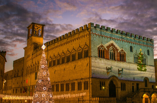 Winter view ofpalace Priori in Perugia at sunset on christmas day with big xmas tree and romantic sky
