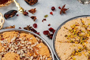 Turkish pastries and scattered dry fruits on table
