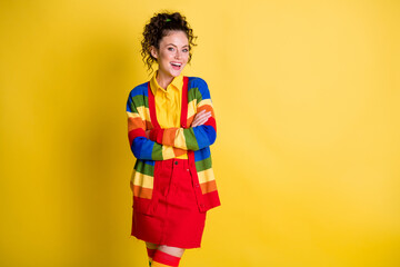 Portrait of attractive glad cheerful wavy-haired girl folded arms isolated over bright yellow color background