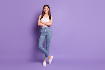 Fototapeta na wymiar Full body photo of cheerful brown haired happy girl crossed hands wear white singlet isolated on purple color background