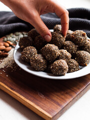 Seed and cardamom date balls in a rustic natural light setting