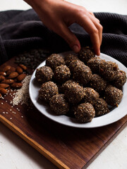 Seed and cardamom date balls in a rustic natural light setting