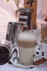 Hot cafe latte in glass with blur background, cafe photo concept.