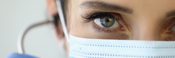 Confident look doctor in protective medical mask. Coronavirus pandemic and doctors 'fight for...