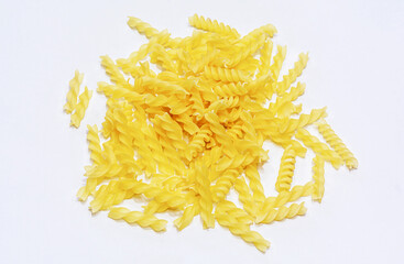 Uncooked raw Italian fusilli pasta on isolated white background.