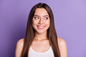 Fototapeta premium Photo portrait of smiling girl looking to side isolated on vivid purple colored background