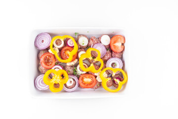 raw meat balls with vegetables and microgreens isolated on white