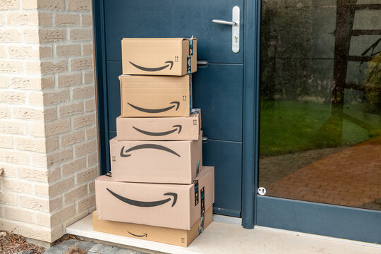 Lille, France - December 18, 2020 : delivery of an amazon order in front of a house.